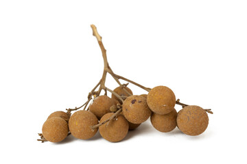 View of longan fruit with a brown, rough skin, still attached to a woody stem. The fruits are round and appear to be ripe, with some slight blemishes on their surface.