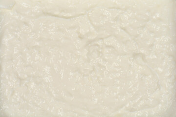 A full-frame, detailed close-up of a smooth, creamy texture of fresh cottage cheese