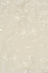 A full-frame, detailed close-up of a smooth, creamy texture of fresh cottage cheese