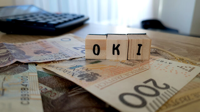 OKI acronym made of wooden letter cubes. Osobiste Konto Inwestycyjne (Personal Investment Account)