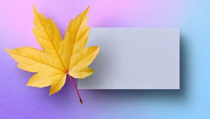 Vibrant autumnal leaf beside a blank card