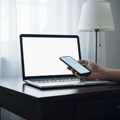 Person Holding Smartphone Near Open Laptop on Wooden Desk