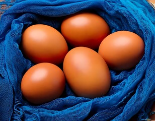 Nest of brown eggs in a blue cloth