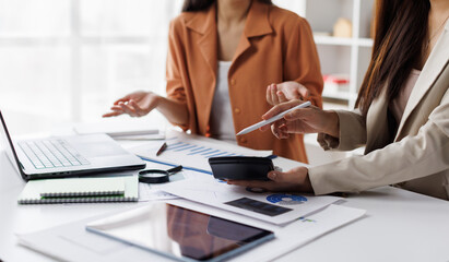 Business financial, accountant discussing with partner are meeting to audit finance planning sales to meet targets set in next year. stock market concept..