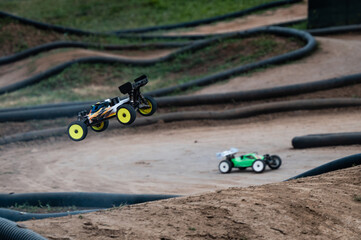 Radio-controlled car jumping on a dirt track during a race competition © Zoran Jesic