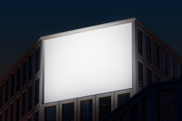 Obraz premium Urban building facade with large glowing billboard mockup at night for advertising concept design presentation or city branding display setup. 3D Rendering