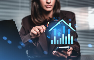 Businesswoman analyzing real estate interest rate trends using d