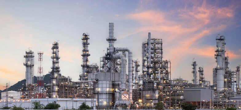 Oil and gas industrial refinery at twilight, Oil refinery and Petrochemical plant pipeline steel, Refinery factory oil storage tank and pipeline steel at night.