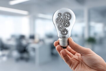 Hand holding a lightbulb filled with intricate gears symbolizing innovation and mechanical ideas in business.