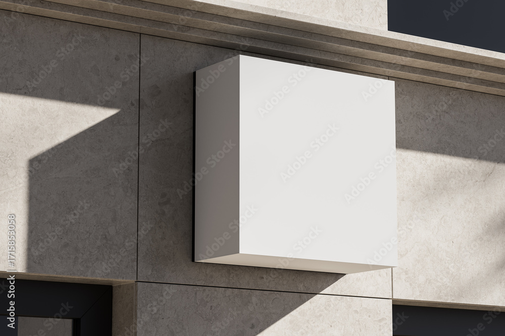 Poster blank square signage mockup mounted on modern stone wall facade with sharp shadows during sunny dayl