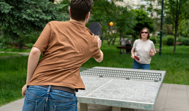 Table tennis in park. Ping pong summer sport outside, people play pingpong, table tennis game