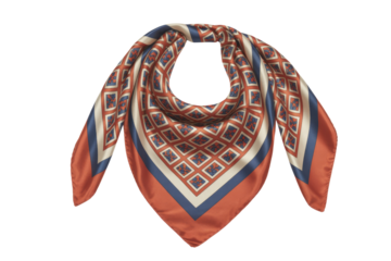 A rust and navy patterned silk scarf, folded elegantly, isolated on a transparent background. background removed