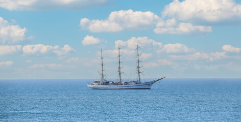 three-masted sailing ship at sea