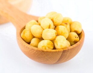 Small, light-yellow seeds in wooden spoon