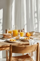 Sunlit breakfast scene featuring orange juice, sliced oranges, toast, and a linen napkin on a wooden table near a sheer curtain