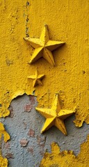 Three weathered, yellow, five-pointed stars affixed to a peeling, yellow wall; varying sizes; distressed texture