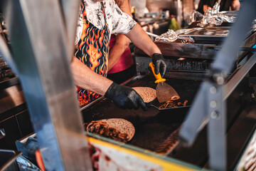 Chef preparing street food quesadillas on a hot griddle