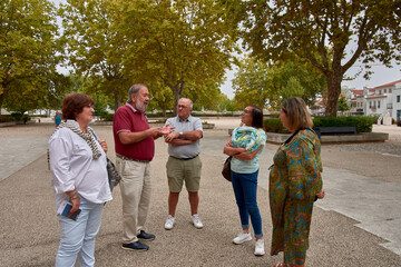 A group of retirees listening attentively to an explanation, enjoying a cultural trip in a historic setting.