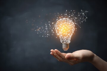 Human hand holding a glowing abstract digital lightbulb representing innovation and new ideas.