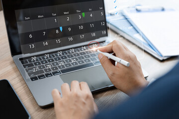 Businessman using laptop to highlight appointment reminders and meeting agenda.