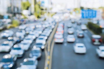 Obraz premium blurred out of focus view to street road full with traffic cars and buses transportation in day time in Chengdu city center, blurred traffic jam transportation