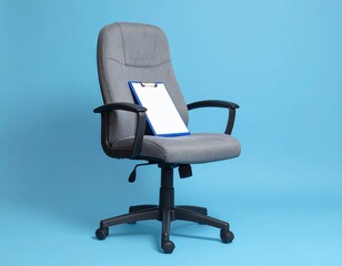 Fototapeta premium A Clipboard on a Gray Office Chair with a Blue Background