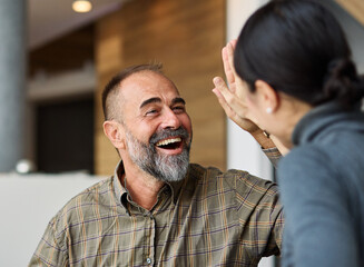Fototapeta premium A portrait of mid aged businessman celebrating during a business meeting or conference seminar in the office or in classroom