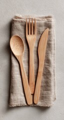Light beige linen napkin with a set of wooden cutlery