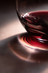 Crimson Elixir: An elegant, artistic close-up reveals the rich, ruby essence of a premium vintage. The glass's curves reflect the light.