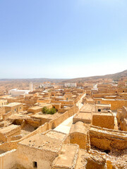 Visitors admire the unique stone structures and natural beauty of Toudjane, Tunisia, where history and landscape come together on a sunny day.