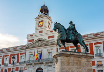 Fototapeta premium Post office building and statue of king Charles III on Puerta del Sol square, Madrid, Spain