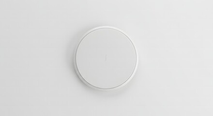 Fototapeta premium A minimalist white circular flush-mount speaker or detector on a clean white ceiling, blending seamlessly with the modern interior design.