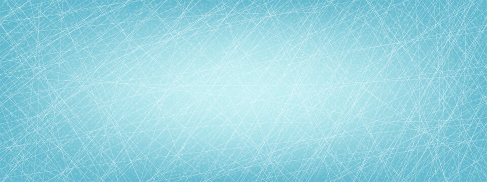 Winter background with a hockey scratched ice texture. The cool blue surface is covered with chaotic white lines, resembling skate marks on a frozen ice rink for sports or holiday themes