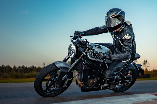 Latvia, Riga, 2025-09-10, regular training. A solitary rider navigates the twilight on a sleek motorcycle