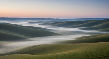 rolling green hills valley fog sunrise