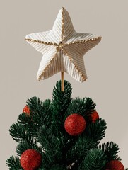 The image is of a christmas tree with a star-shaped decoration on top. the tree is made of green needles and is decorated with red baubles.