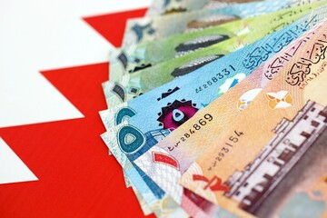 Bahraini dinar currency money bills lies on flag. The concept of business and investment