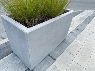 Modern concrete planter with clean lines and minimal design. Contemporary outdoor decoration for gardens, terraces, or patios.