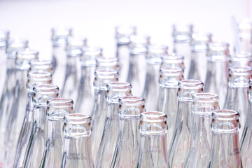 Many empty glass bottles are stacked together.