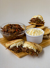 Delicious Venezuelan arepa stuffed with shredded beef and cheese, a traditional Latin American street food dish