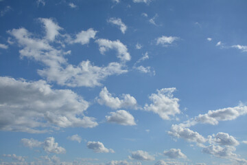 Small white clouds on the blue sky background