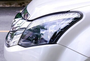 Obraz premium Close-up of the front lights of a white car.