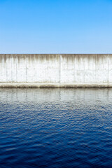 青空と堤防のある汽水域