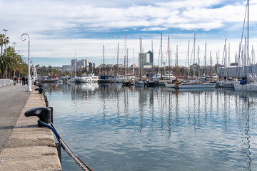 Barcelona, Spain-April 12, 2023. A tranquil scene of a sailboats gliding in the harbor with...