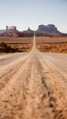 Fototapeta premium Road leading to monument valley under a clear blue sky in the american southwest area
