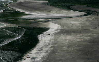 Generated ImaAbstract texture of black volcanic sand mixed with white sea salt on the beach of the Faroe Islands, captured in high detail.ge