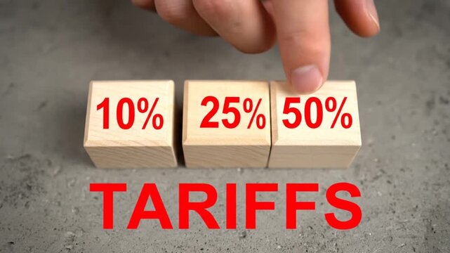 Hand placing wooden blocks with percentage values 10 25 50 above the word tariffs