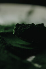 Spirulina powder close up, green superfood, organic healthy supplement