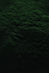 Spirulina powder close up, green superfood, organic healthy supplement