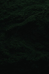 Spirulina powder close up, green superfood, organic healthy supplement